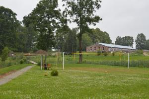 a park with a volley ball net in a field at Guest House Kalnu pūpoli in Šengeida