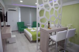 a living room with a bed and a table and chairs at Lazuli Sea View-Beachfront Ap 405 in Larnaca