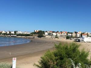 a view of a beach with people in the water at residence parc de pontaillac in Vaux-sur-Mer