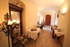 a dining room with tables and chairs and a hallway at Hotel-Appartement-Villa Ulenburg in Dresden