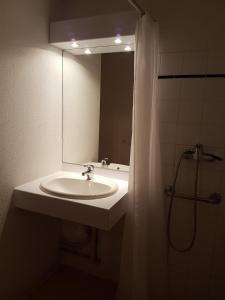 a bathroom with a sink and a mirror at Résidence Goélia Le Relais des Pistes in Albiez-le-Vieux