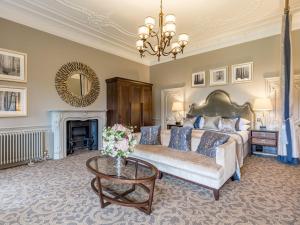 a living room filled with furniture and a fireplace at Rhinefield House Hotel in Brockenhurst