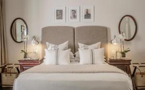 a bedroom with a large bed with white pillows at Torburnlea Homestead Luxury Accommodation in Nelspruit