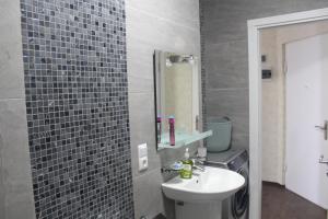 a bathroom with a sink and a mirror at Gorgiladze Seaside Apartment in Batumi +33 photos