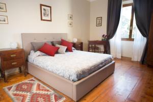 Un dormitorio con una cama con almohadas rojas. en San Giacomo Bed & Breakfast, en Verona