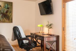 a bedroom with a desk with a chair and a lamp at River Spring Lodge in Darien