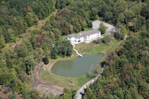 an aerial view of a large house with a lake at River Spring Lodge in Darien