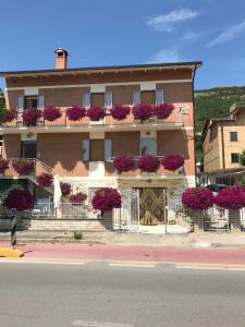 a building with flower boxes on the balconies at La Signora Dei Fiori in Gubbio