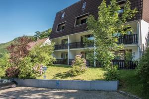 an apartment building with a car parked in front of it at Haus Behrendt in Zorge