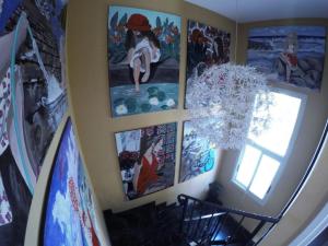a room with paintings on the wall and a chandelier at Villa Galleria in Perivolia