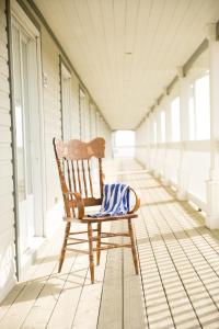 a rocking chair on the porch of a house at Château Madelinot in Fatima