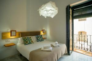 a bedroom with a bed with towels on it at Eva Recommends Casa Gerona in Seville