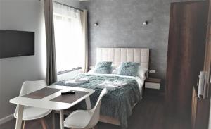Postel nebo postele na pokoji v ubytování Vigan Apartamenty
