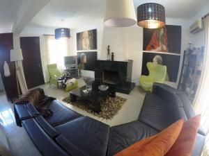 a living room with a couch and a fireplace at Villa Galleria in Perivolia