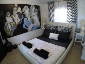 a bedroom with a bed with a large painting on the wall at Villa Galleria in Perivolia