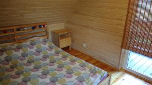 a small bedroom with a bed and a window at Domek nad morzem Mechowo in Mechowo