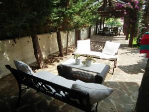 a patio with two chairs and a table at Villa Galleria in Perivolia