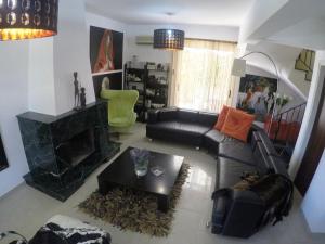 a living room with a couch and a fireplace at Villa Galleria in Perivolia