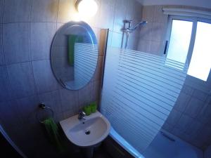 a bathroom with a sink and a mirror and a shower at Villa Galleria in Perivolia