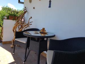 a small table and chairs on a patio at Casuta dintre dealuri in Vlădeşti