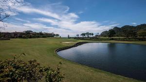 a pond in the middle of a golf course at Ocean View Condo in Los Sueños in Herradura