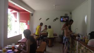 a group of people sitting in a room at Pousada Rio e Mar in Massarandupio