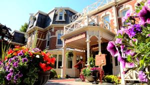 a large house with flowers in front of it at Prince of Wales in Niagara-on-the-Lake