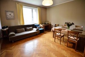 a living room with a couch and a table at Apartament Krych in Rabka-Zdrój