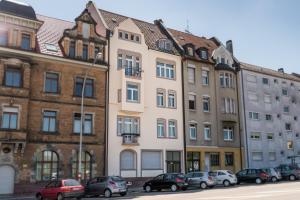 ein hohes Gebäude mit davor geparkt in der Unterkunft Family-Apartments Freiburg in Freiburg im Breisgau