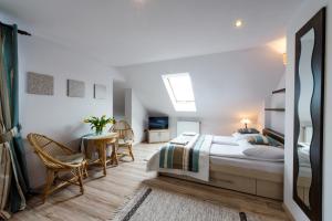 sypialnia z łóżkiem, stołem i krzesłami w obiekcie Apartamenty Królewska Kwatera w mieście Zamość