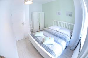 Posteľ alebo postele v izbe v ubytovaní Apartamenty Zamkowa