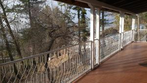 a balcony with a view of a tree at Pine Top Hotel Murree in Murree
