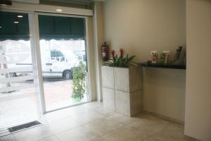 a room with a sliding glass door with a potted plant at Hostal El Altet in El Alted