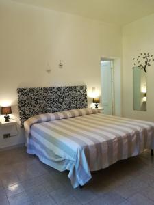 a bedroom with a large bed in a room at Casa Simonetta in Castellina Marittima