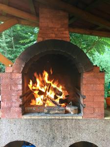a brick oven with a fire in it at Pensiunea Silva Dobra in Şugag