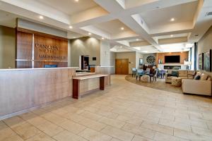 a lobby of a hotel with a reception counter at Canalta Martensville in Martensville