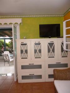 a large white entertainment center with a television on top at Abades Chalet in Abades