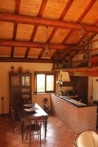 a kitchen and dining room with a table in a room at Mount Etna Chalet in Maletto
