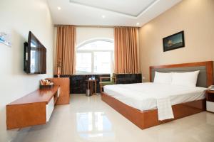 a hotel room with a bed and a tv at HalongSeoul Hotel in Ha Long +29 photos