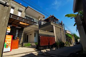 a building with a balcony on the side of it at Suwardika Homestay & Dormitory in Sanur