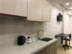 a kitchen with a sink and a counter top at Umali Kayo at Megatower Residences II in Baguio