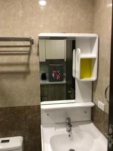 a bathroom with a sink and a mirror at Umali Kayo at Megatower Residences II in Baguio +19 photos