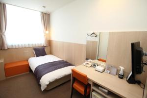 Postel nebo postele na pokoji v ubytování New Commander Hotel Osaka Neyagawa