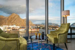 a living room filled with furniture and a balcony at Thon Hotel Lofoten in Svolvær