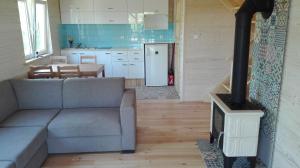 a living room with a couch and a stove at Domek nad morzem Mechowo in Mechowo +20 photos