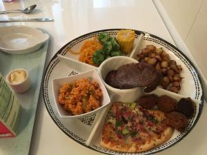 a plate of food with different foods on a table at Love & Peace in Orpington