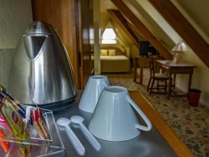 a table with two white mugs on top of it at LOGIS - Belle Hôtel, Lille-Ouest in Bailleul
