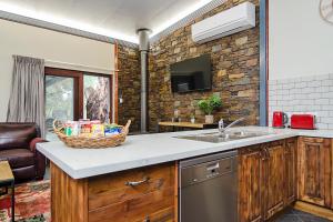 a kitchen with a sink and a basket on the counter at Eagle Foundry Bed & Breakfast in Gawler