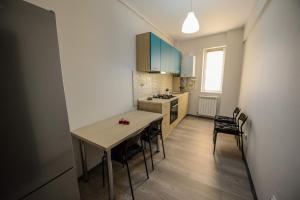 a kitchen with a table and chairs in a room at Magnum Residence in Mamaia Nord