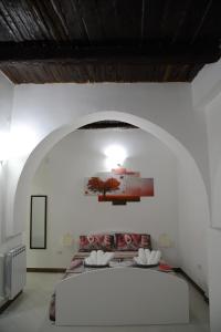 una camera con un grande letto su una parete bianca di Salerno Mare e Luci a Salerno